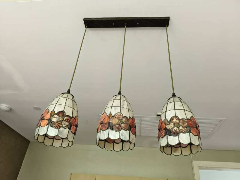 Three pendant ceiling lights with a floral design.