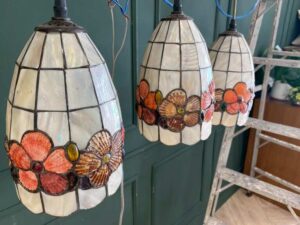 Three pendant ceiling lights with a floral design.