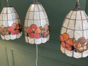 Three pendant ceiling lights with a floral design.