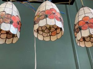 Three pendant ceiling lights with a floral design.