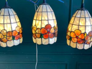 Three pendant ceiling lights with a floral design.