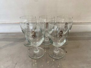 Short-stemmed wine glass with military logo printed on it.