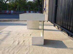 Multipurpose wooden table, white with clear glass top legs.