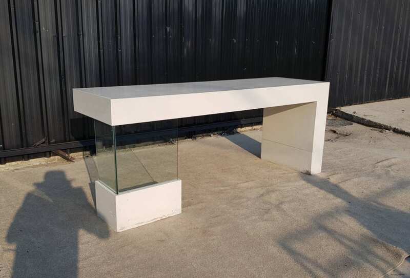 Multipurpose wooden table, white with clear glass top legs.