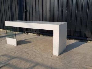 Multipurpose wooden table, white with clear glass top legs.