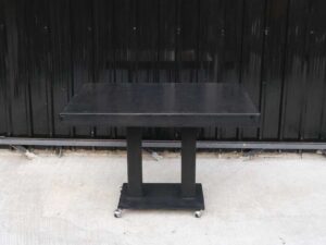 Black wooden frame table, steel legs, with wheels, hotel grade work._L94DQ0PP0K