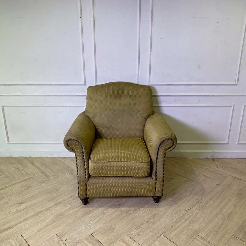 Armchair with wooden legs and brown fabric seat with yellow polka dots._56GGMRE4ZV_LM5WUKN0TZ