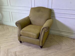 Armchair with wooden legs and brown fabric seat with yellow polka dots._56GGMRE4ZV_LM5WUKN0TZ