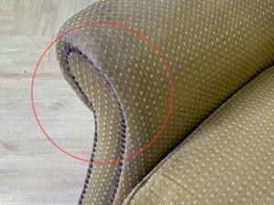 Armchair with wooden legs and brown fabric seat with yellow polka dots._56GGMRE4ZV_LM5WUKN0TZ
