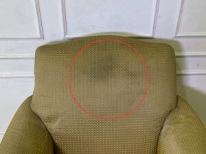 Armchair with wooden legs and brown fabric seat with yellow polka dots._56GGMRE4ZV_LM5WUKN0TZ