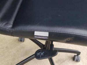 Modernform brand office chair with leather seat, backrest, and steel legs.