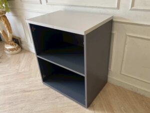Two-tiered wooden filing cabinet with cable management compartment, gray color.