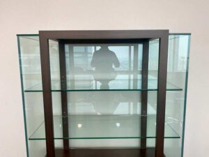 Three-tiered glass display case with wooden frame