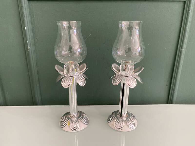 Silver glass-encased candlestick lamp.