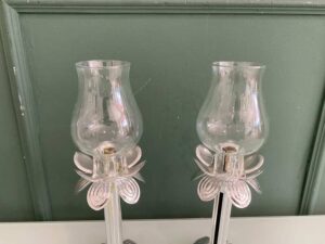 Silver glass-encased candlestick lamp.
