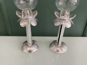Silver glass-encased candlestick lamp.
