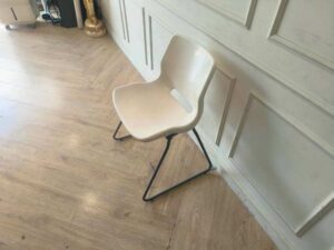 Plastic chair with metal legs, IKEA brand, SNILLE model.