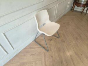 Plastic chair with metal legs, IKEA brand, SNILLE model.