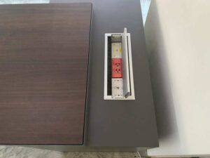Executive L-shaped corner desk with 3 drawers, 2 shelves, and power strip. PROFLEX brand.