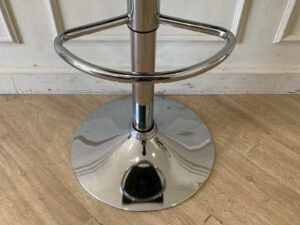 Bar stool with steel legs and black leather seat.