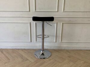 Bar stool with steel legs and black leather seat.