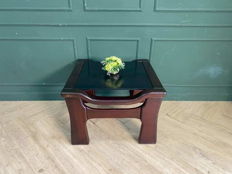 Wooden coffee table with glass top, solid gray color.