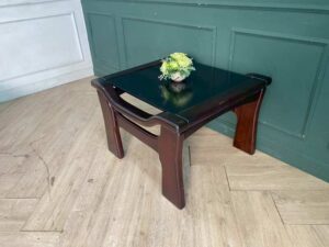Wooden coffee table with glass top, solid gray color.