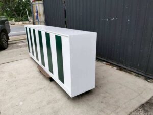 Multipurpose wooden storage cabinet with 6 compartments, white with green stripes.