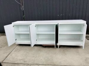 Multipurpose wooden storage cabinet with 6 compartments, white with green stripes.