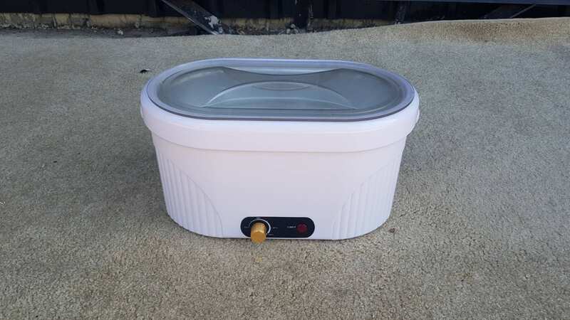 Electric paraffin wax heater with adjustable temperature, white color.