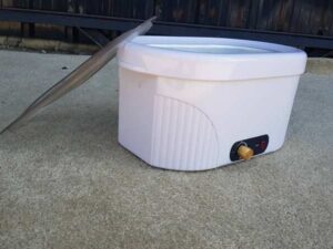 Electric paraffin wax heater with adjustable temperature, white color.