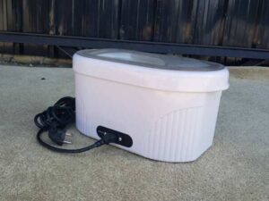Electric paraffin wax heater with adjustable temperature, white color.