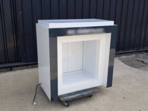 Two-door wooden display cabinet, white and black.