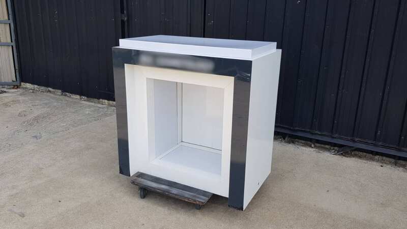 Two-door wooden display cabinet, white and black.