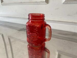 Red Mason Jar-shaped mug with handle and embossed lettering.