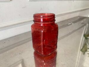 Red Mason Jar-shaped mug with handle and embossed lettering.
