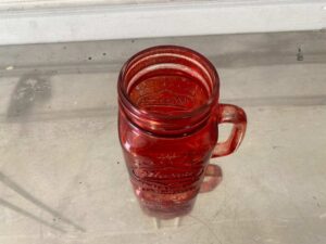 Red Mason Jar-shaped mug with handle and embossed lettering.