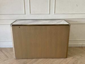A rectangular, modern luxury wooden cabinet with two doors, in brown with gold stainless steel trim.