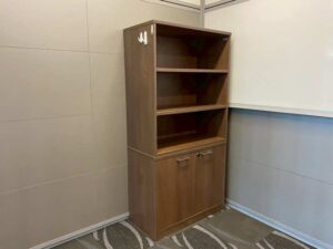 Tall filing cabinet with 2 doors and 3 shelves, brown wooden frame