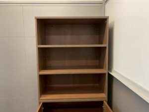 Tall filing cabinet with 2 doors and 3 shelves, brown wooden frame