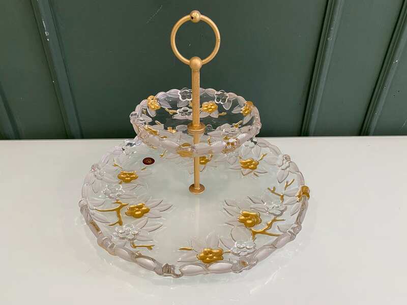 Two-tiered glass dessert and fruit stand with floral design and gold rim, European style.
