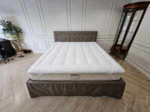 6-foot bed with button tufting, grey fabric mattress, and a 6-foot white topper.