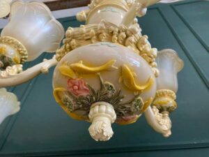 Glass chandelier with fish pattern, cream color.