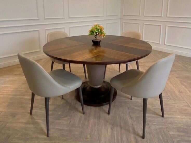 Round dining table set with alternating wood top and chairs.