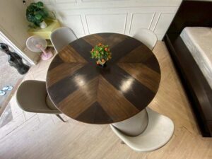 Round dining table set with alternating wood top and chairs.