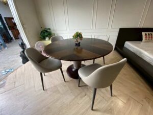 Round dining table set with alternating wood top and chairs.