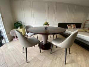 Round dining table set with alternating wood top and chairs.