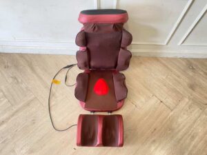 Portable electric massage cushion with remote control, red fabric cushion.