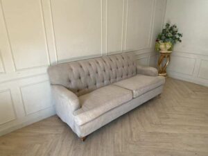 Two-seater sofa, button-tufted fabric upholstery, grey.