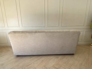 Two-seater sofa, button-tufted fabric upholstery, grey.